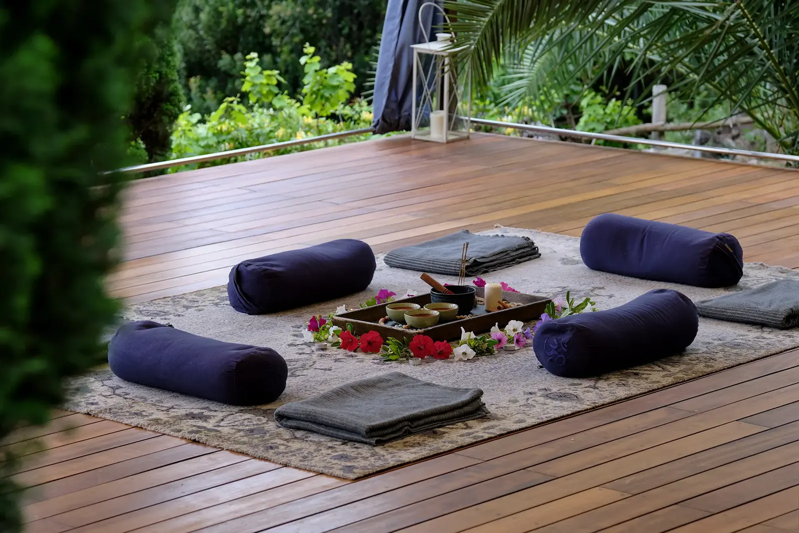 Bolsters and blankets laid out on the shala's wooden floor