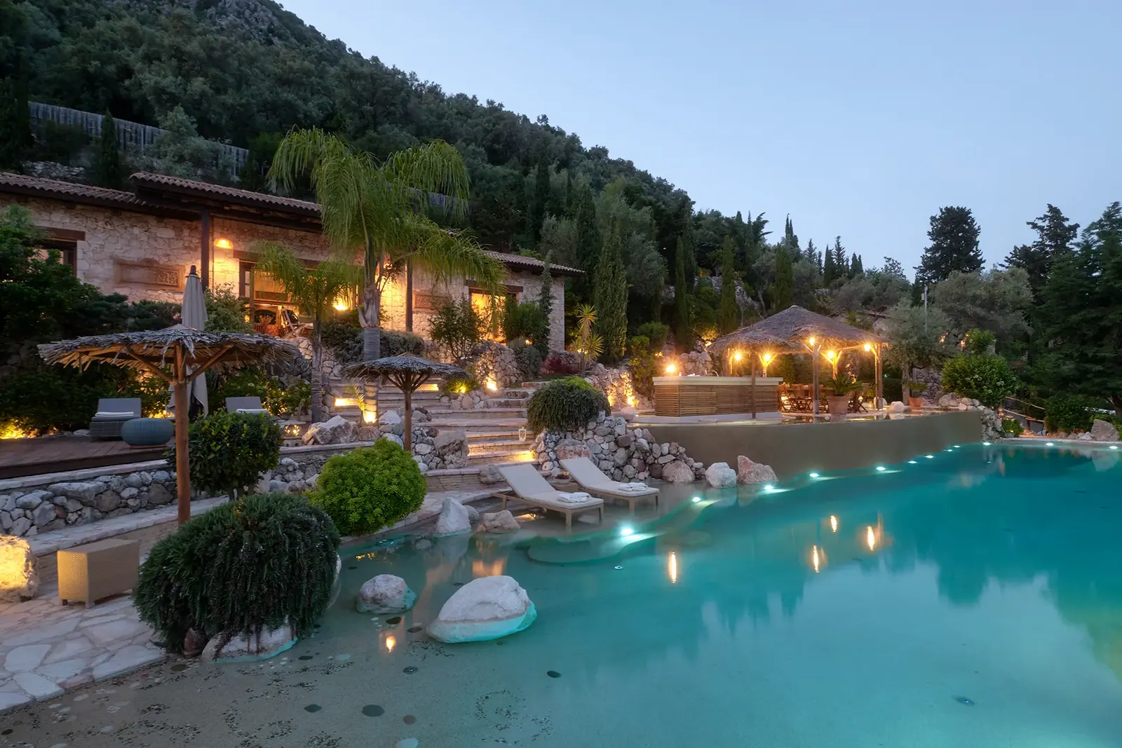 Mimosa's pool and gardens at dusk, above the Ionian Sea
